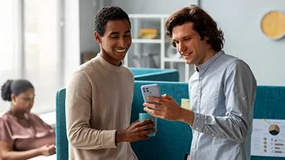 Colleagues looking at mobile phone in an office environment